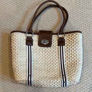 Never used, Straw woven bag with 3 inside pockets, one of which is zippered.